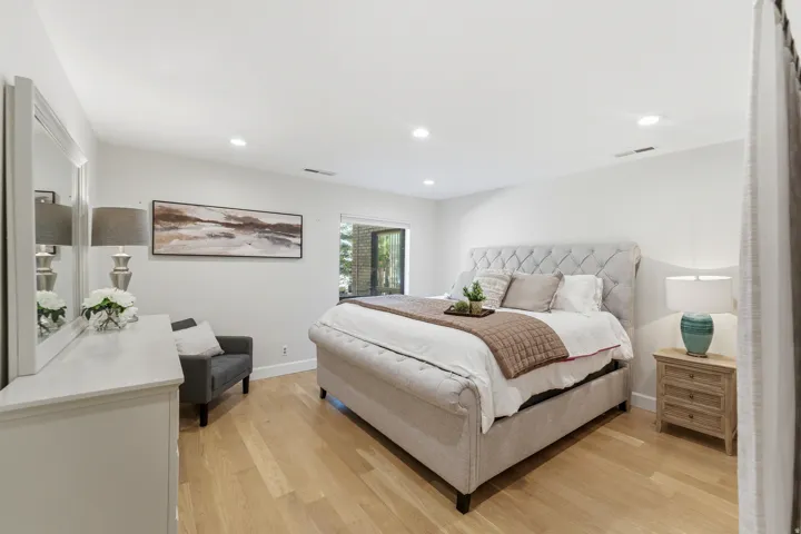 Light wood-finish flooring with white walls