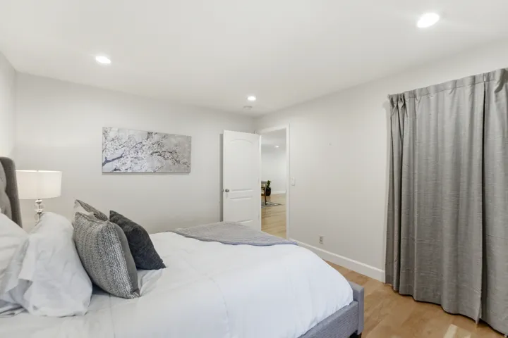 Recessed lighting, light-toned wood-finish flooring, white walls, and white trim