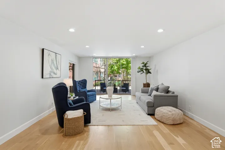 Hardwood-finish flooring, recessed lighting, and a private balcony with iron railings