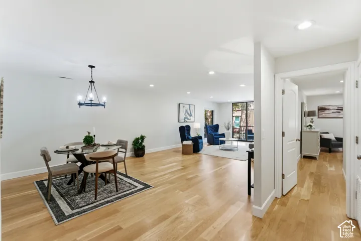 Hardwood-finish flooring throughout, recessed lighting, and a contemporary chandelier
