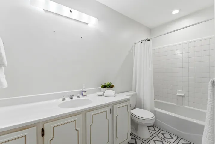 White vanity with an integrated sink and brushed nickel faucet
