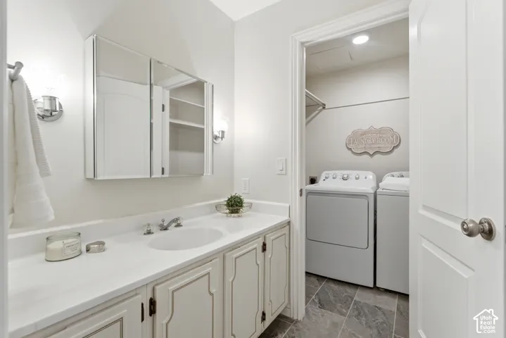 Bathroom vanity with an integrated sink, polished chrome faucet, and mirrored medicine cabinet