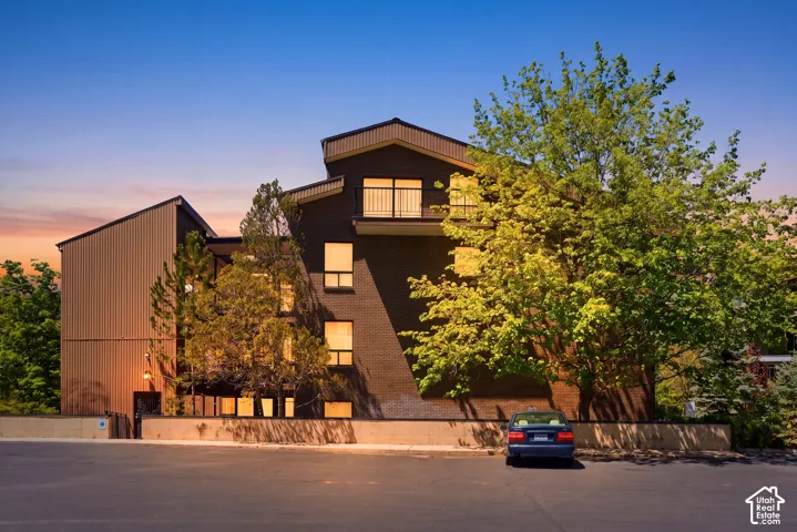 Contemporary architectural design featuring a multi-level structure with stacked geometric forms, corrugated metal cladding, and dark exterior finishes
