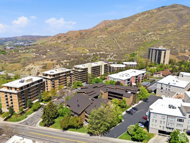 Aerial perspective of multiple residential buildings set against a mountainous backdrop