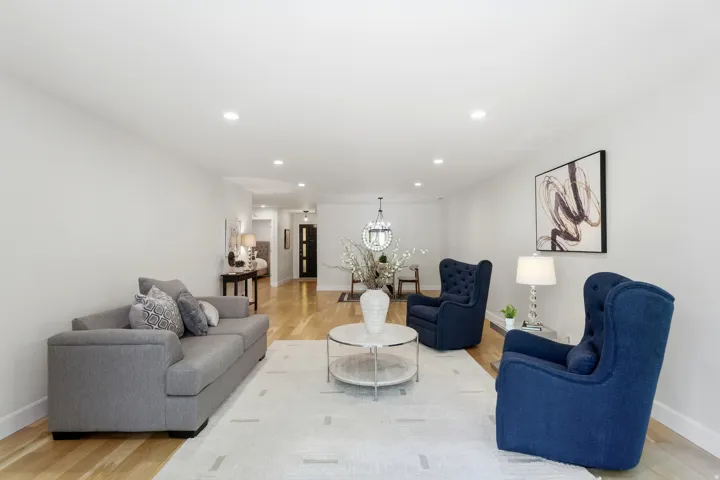 Recessed lighting illuminates the wood-finish flooring
