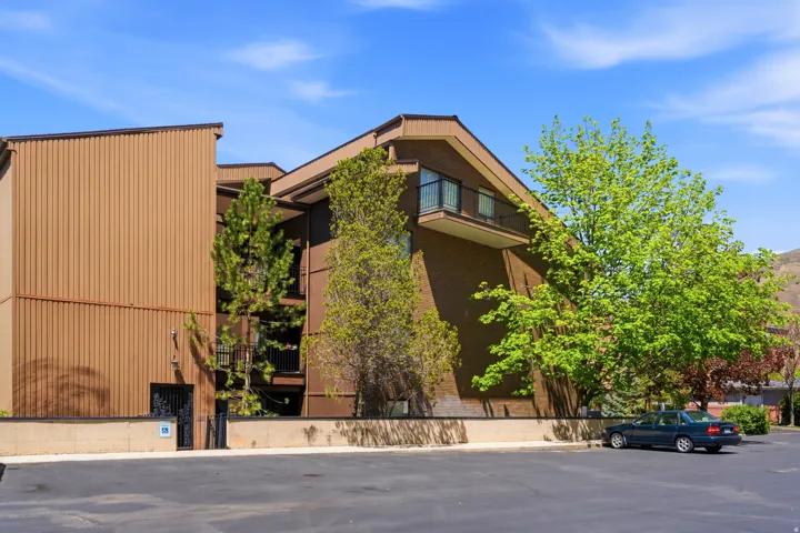 Multi-story building featuring brick and vertical panel siding