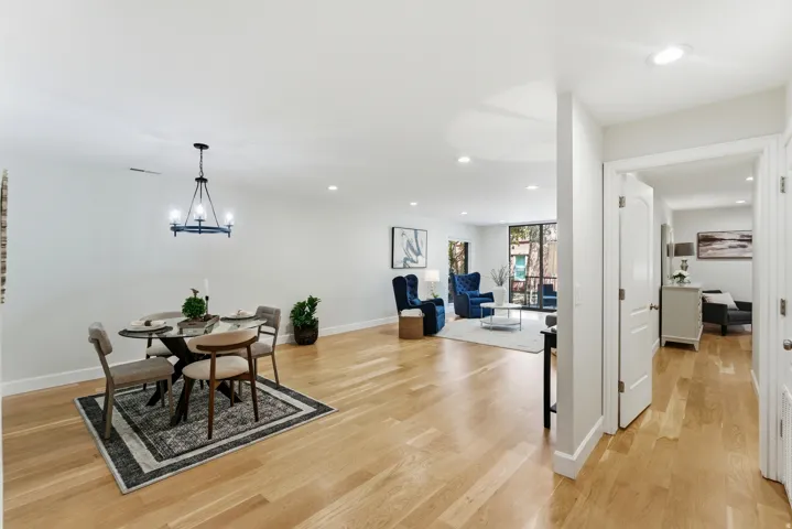 Hardwood-finish flooring throughout, recessed lighting, and a contemporary chandelier