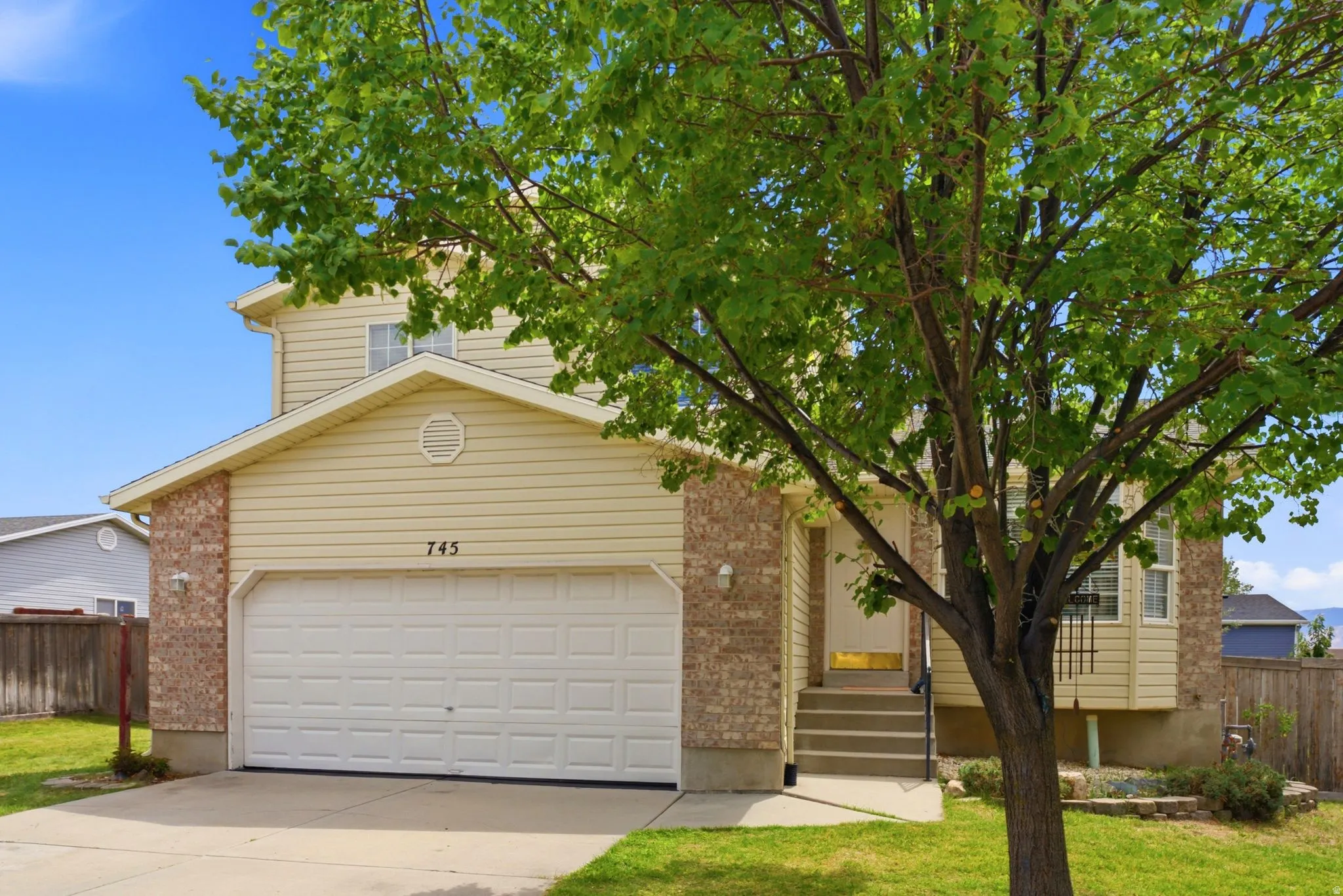 Two-story exterior with light-colored siding and brick accents