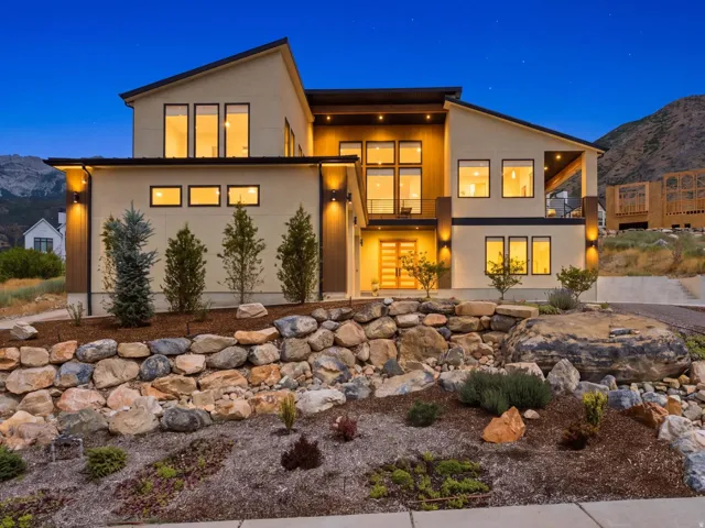 Contemporary exterior with a multi-level design, extensive rock landscaping, and prominent mountain backdrop