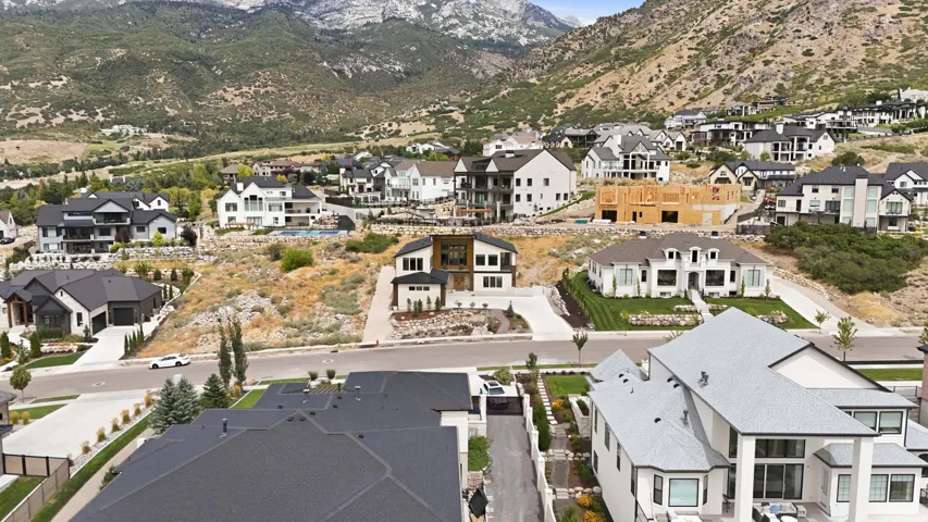 Mountainous backdrop with an expansive residential community featuring diverse architectural styles