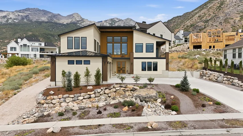 Modern architecture with a flat roofline, multi-pane windows, and a prominent mountain backdrop