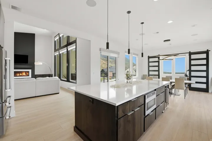 Spacious open-concept interior featuring light wood-finish flooring