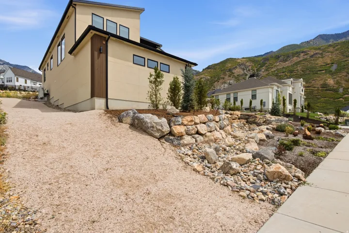 Modern exterior with a flat roofline, stucco siding, and dark trim windows