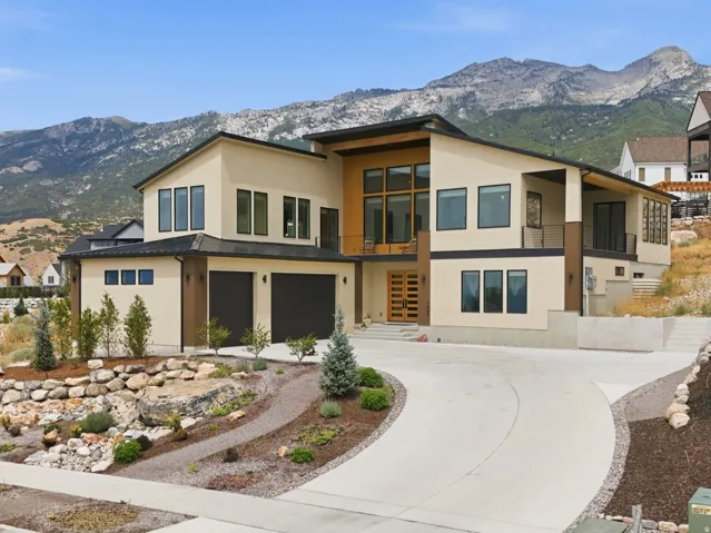 Contemporary architectural design featuring a multi-tone facade and a concrete driveway