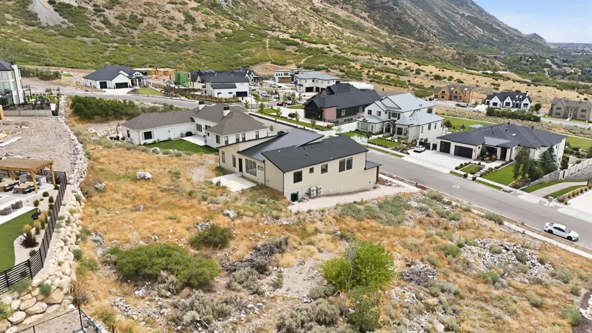 Newly constructed residence with a two-car garage, light-toned siding, and dark roofing