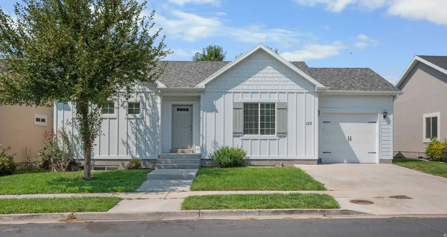 White siding exterior with board and batten accents, shaker shingle gable, and a single-car garage
