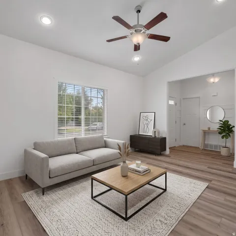 Recessed ceiling lighting, wood-finish flooring, ceiling fan with light fixture, window with horizontal blinds, and a paneled entry door