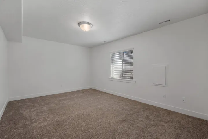 Neutral wall colors, recessed window, and flush-mount ceiling light