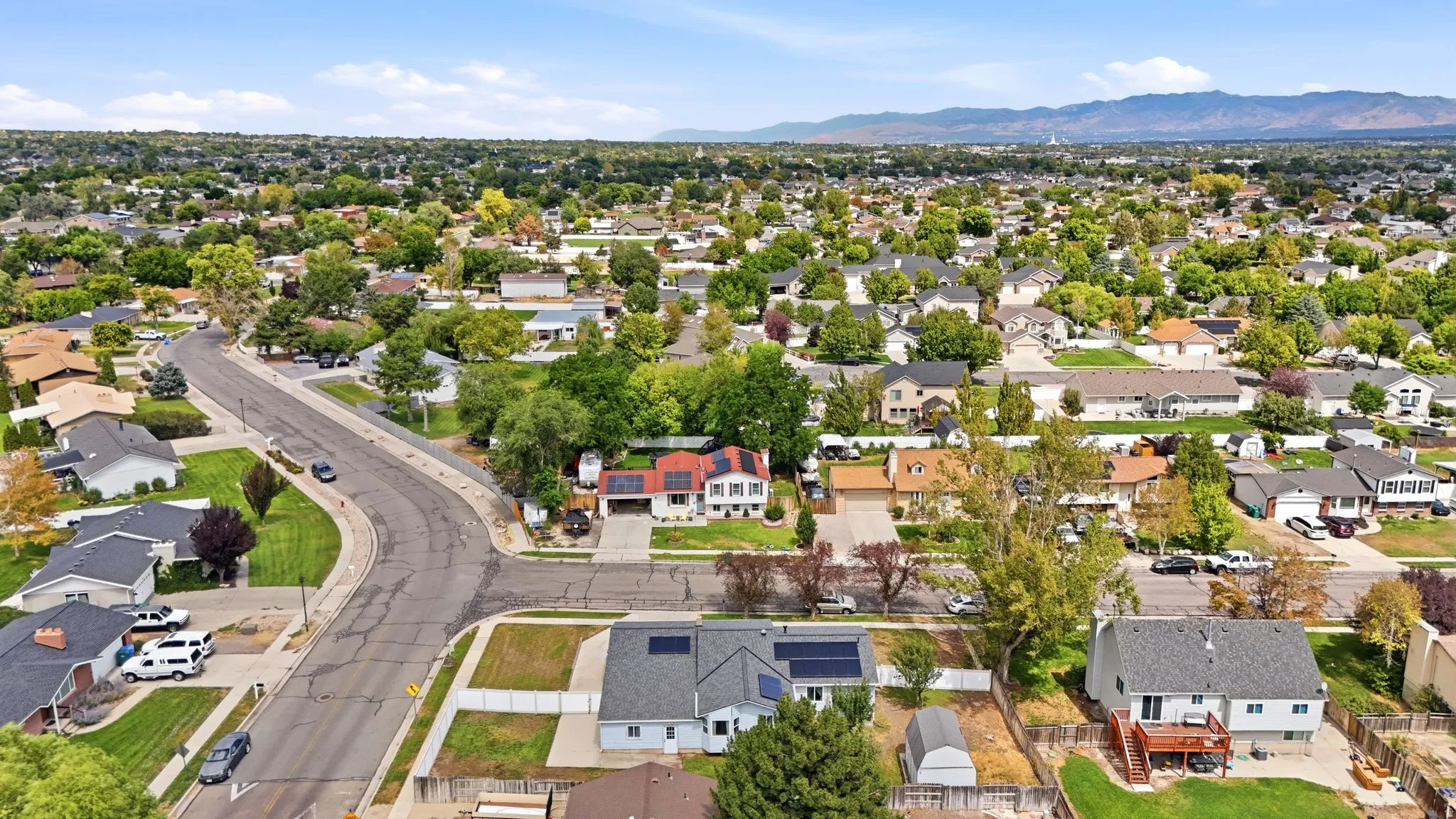 Expansive residential neighborhood with mature trees and mountain backdrop