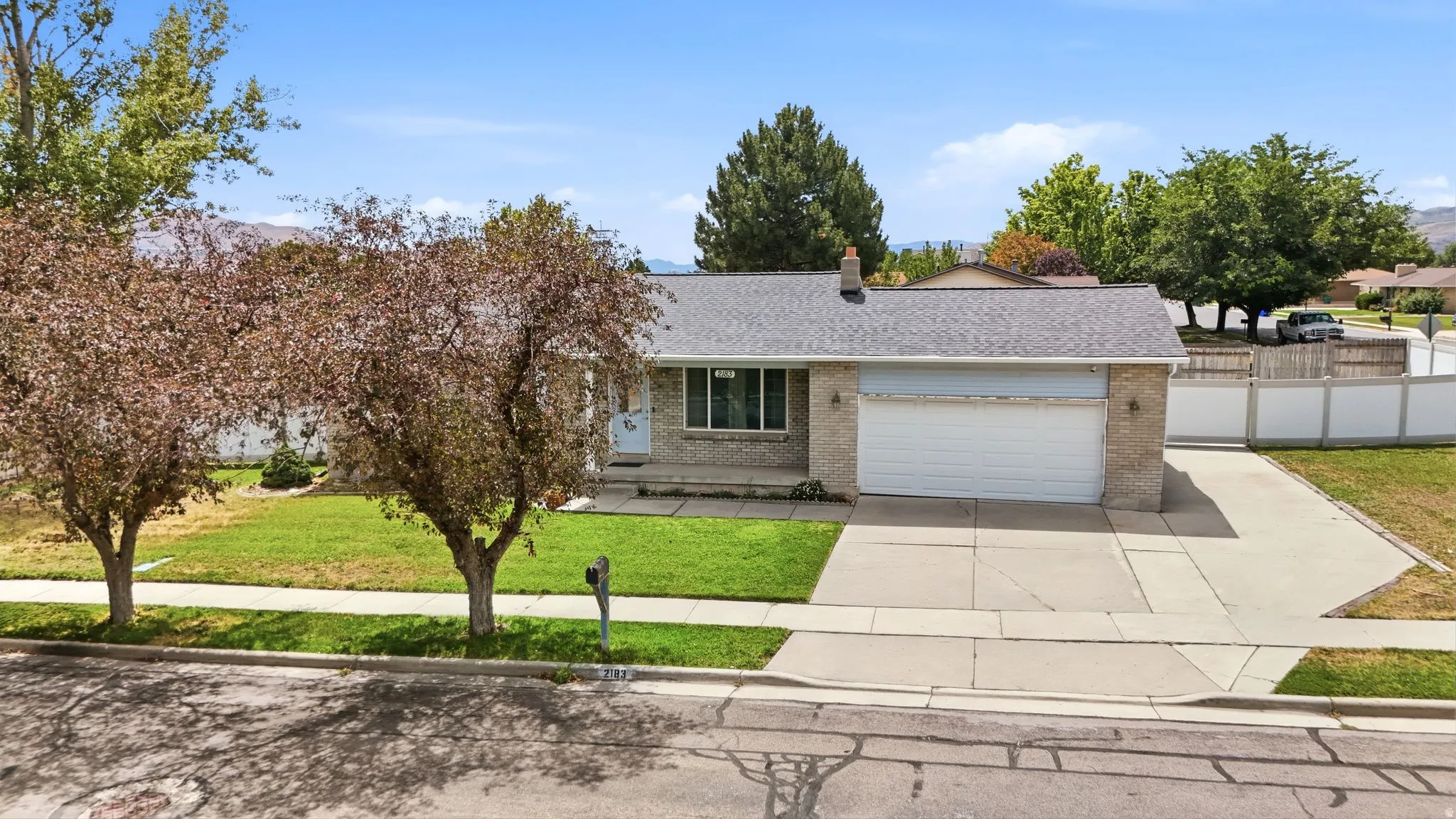 Single-story residence featuring a brick facade, attached two-car garage, and a concrete driveway