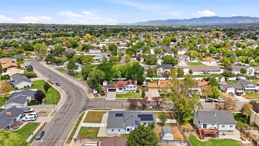 Expansive residential neighborhood with mature trees and mountain backdrop