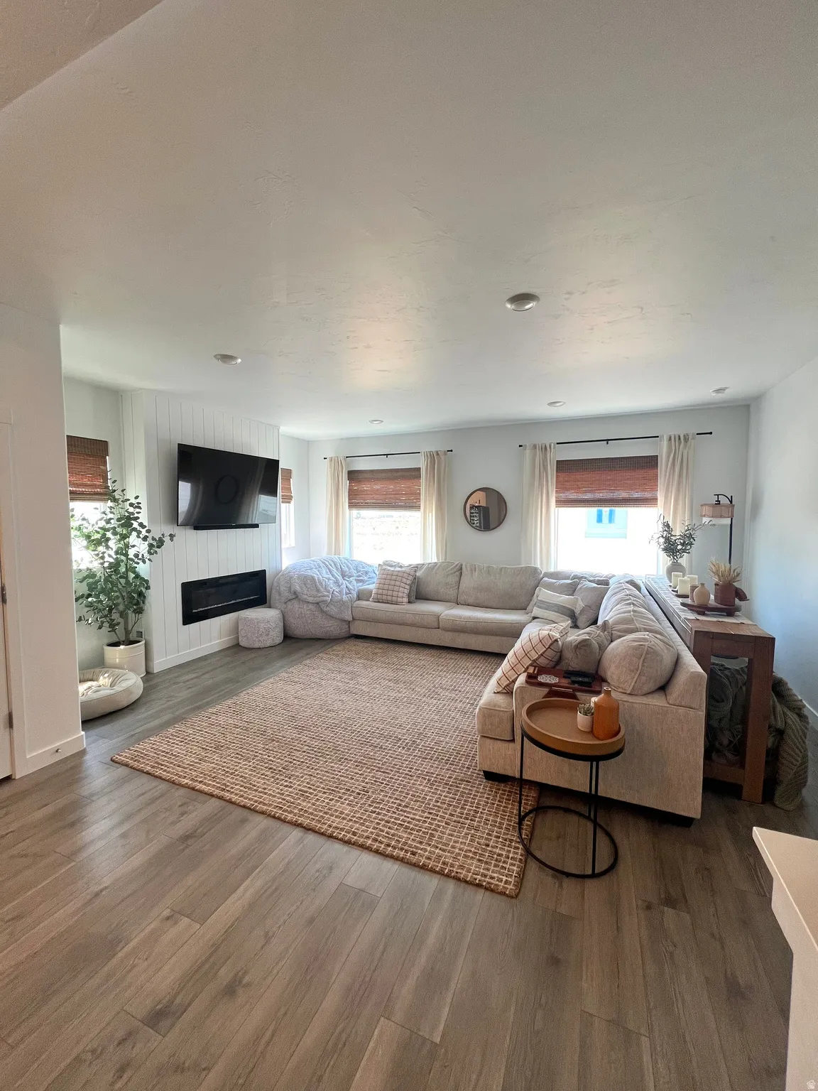 Spacious living area featuring recessed lighting and wood-finish flooring