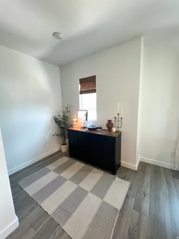Recessed lighting, wood-finish flooring, and white walls