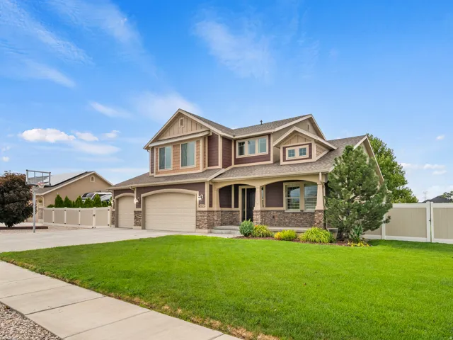 Two-story residence featuring a combination of horizontal siding and stone veneer, multiple gables, and an arched covered entry
