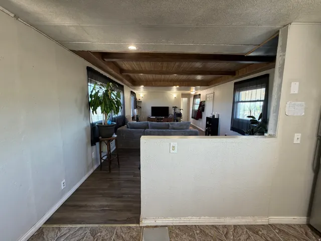 Wood-finish flooring, recessed lighting, and wood-paneled ceiling with exposed beams