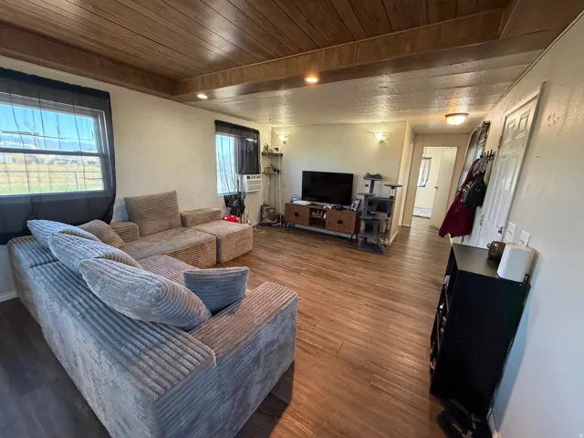 Wood-finish flooring throughout, complemented by a wood plank ceiling