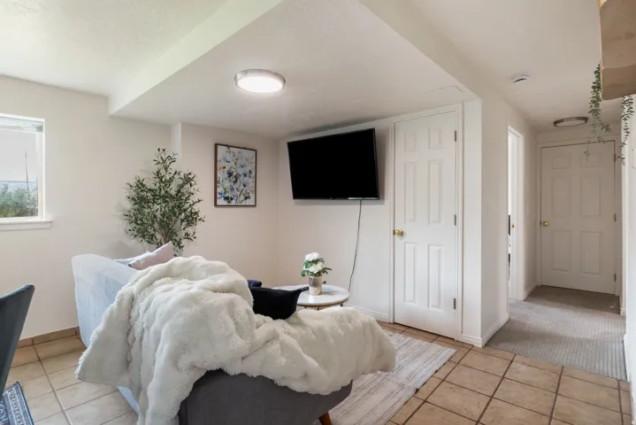 Neutral tone wall paint, recessed lighting, tile flooring, and multiple interior doors