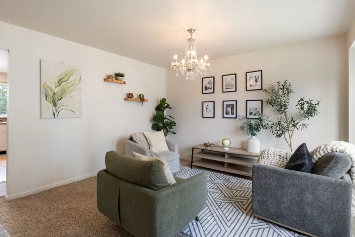 Neutral wall tones, recessed lighting, and a crystal chandelier