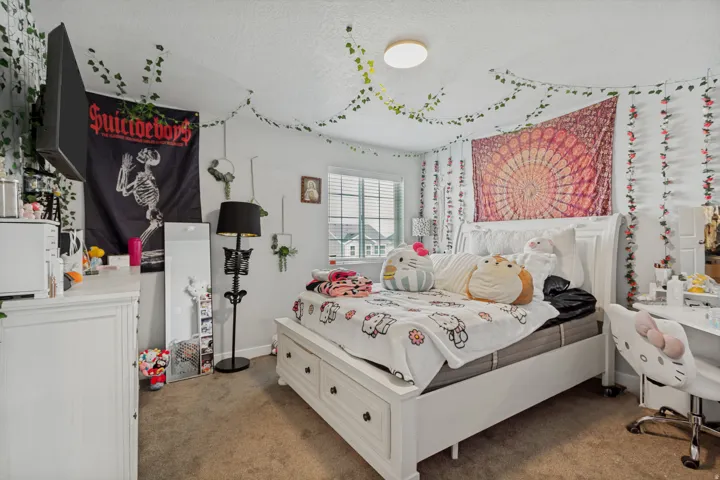 Room featuring a light-colored carpet, a white framed window with blinds, and recessed lighting