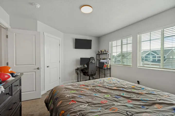 White interior doors, two windows with blinds, and recessed lighting