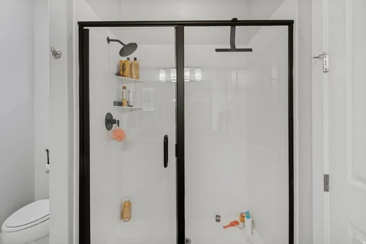 Shower enclosure with clear glass and matte black framing