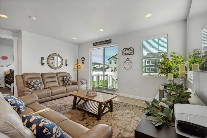 Recessed lighting, wood-finish flooring, sliding glass door, fixed pane window, and light neutral wall colors