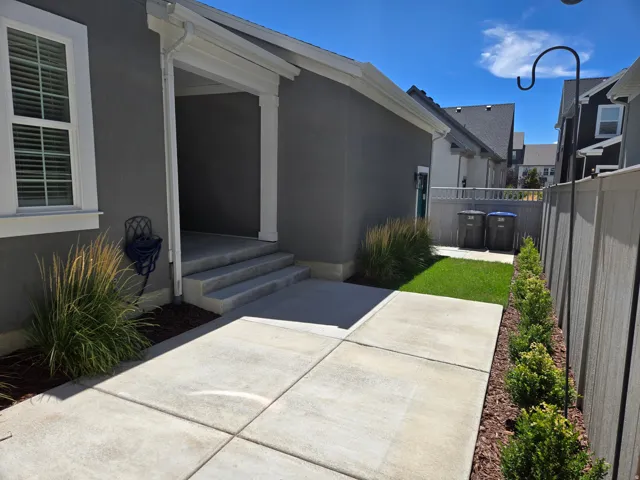 Concrete patio with direct entry, stucco exterior, and mature landscaping