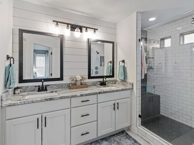 Dual vanity featuring undermount sinks and light-toned countertops