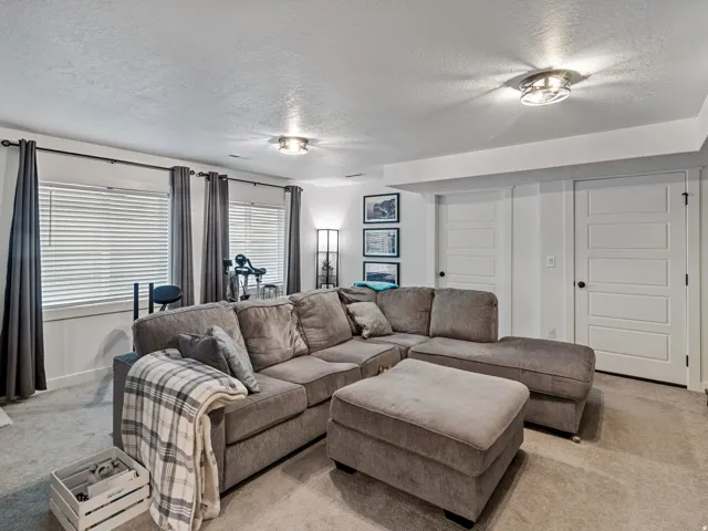 Carpeted flooring, recessed lighting, and multiple windows with blinds