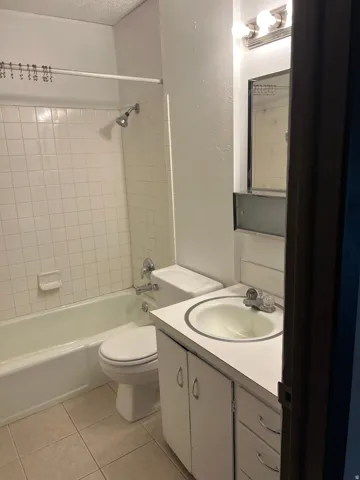 Full bath, tile floor and surround