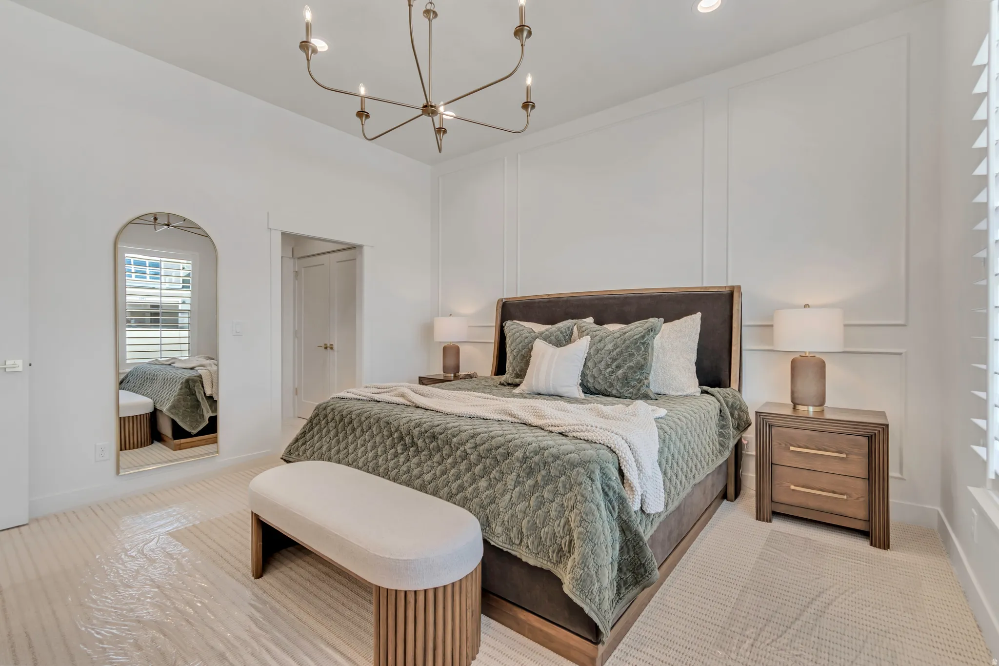 High ceilings with a multi-light chandelier and recessed lighting