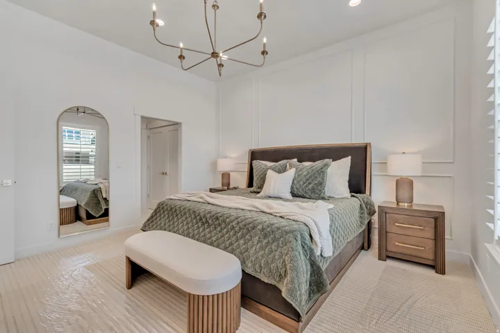 High ceilings with a multi-light chandelier and recessed lighting