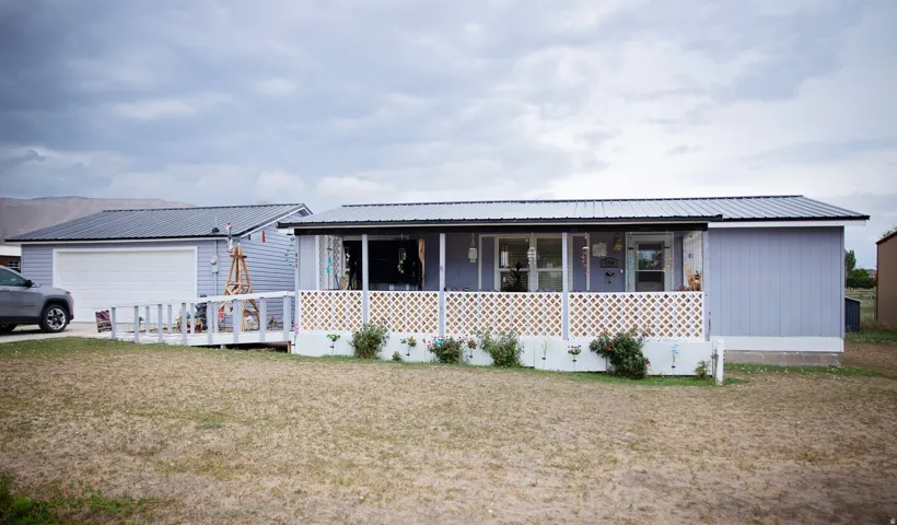 Light blue siding exterior with a metal roof