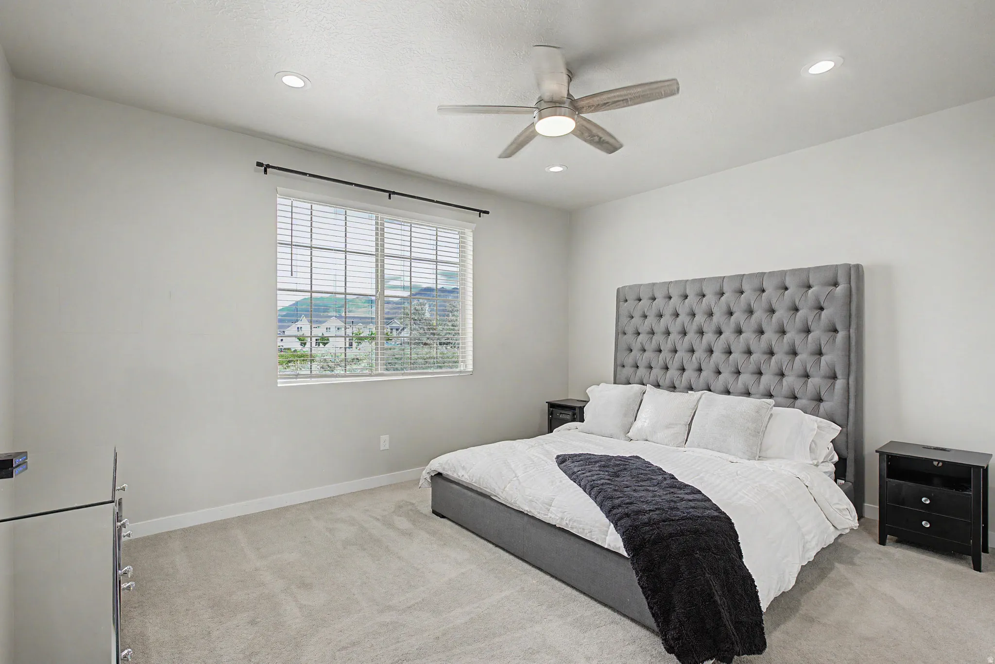 Recessed lighting, ceiling fan, window with blinds, and light gray carpeting