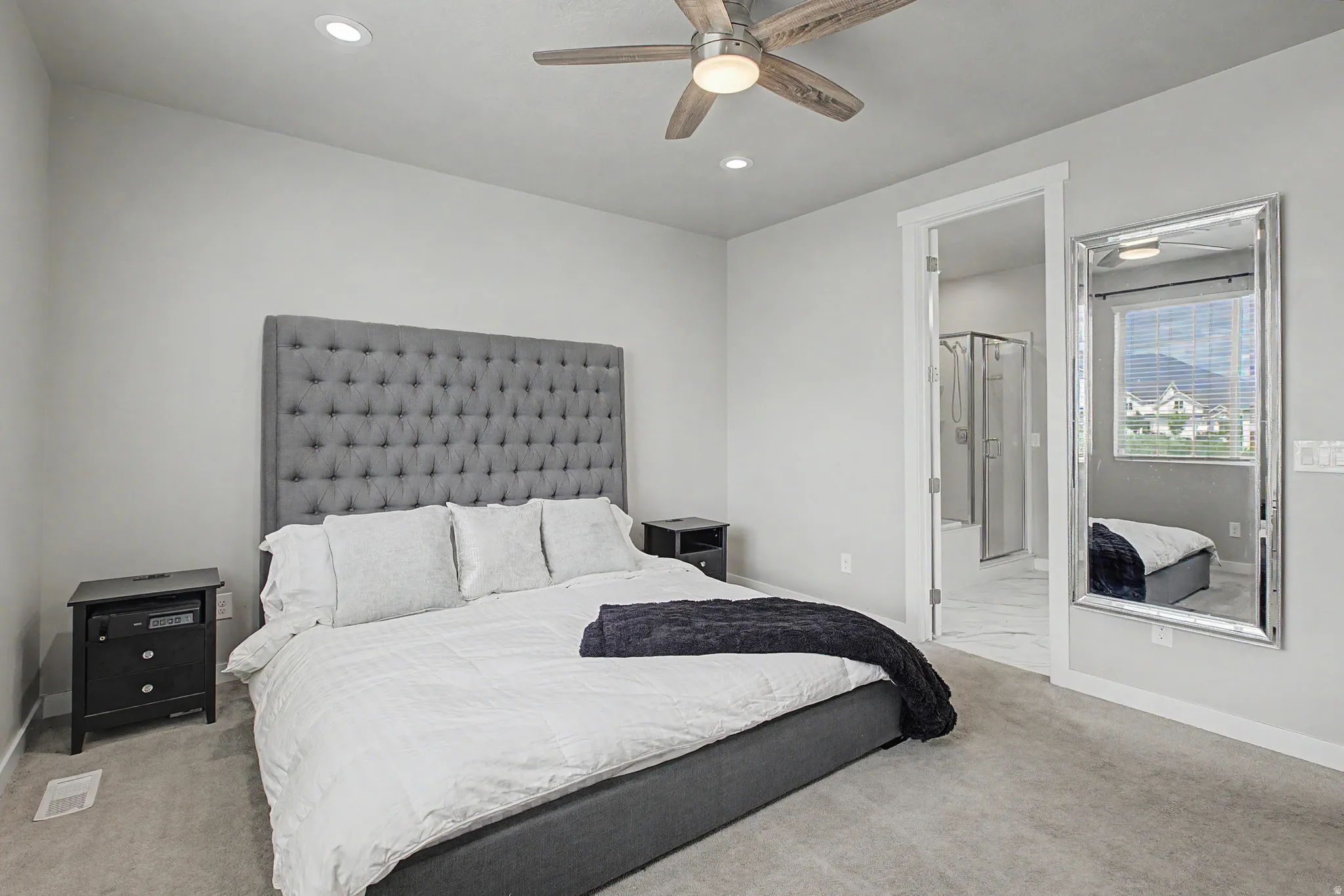 Vaulted ceiling with a wood-finish ceiling fan, recessed lighting, and carpeted flooring