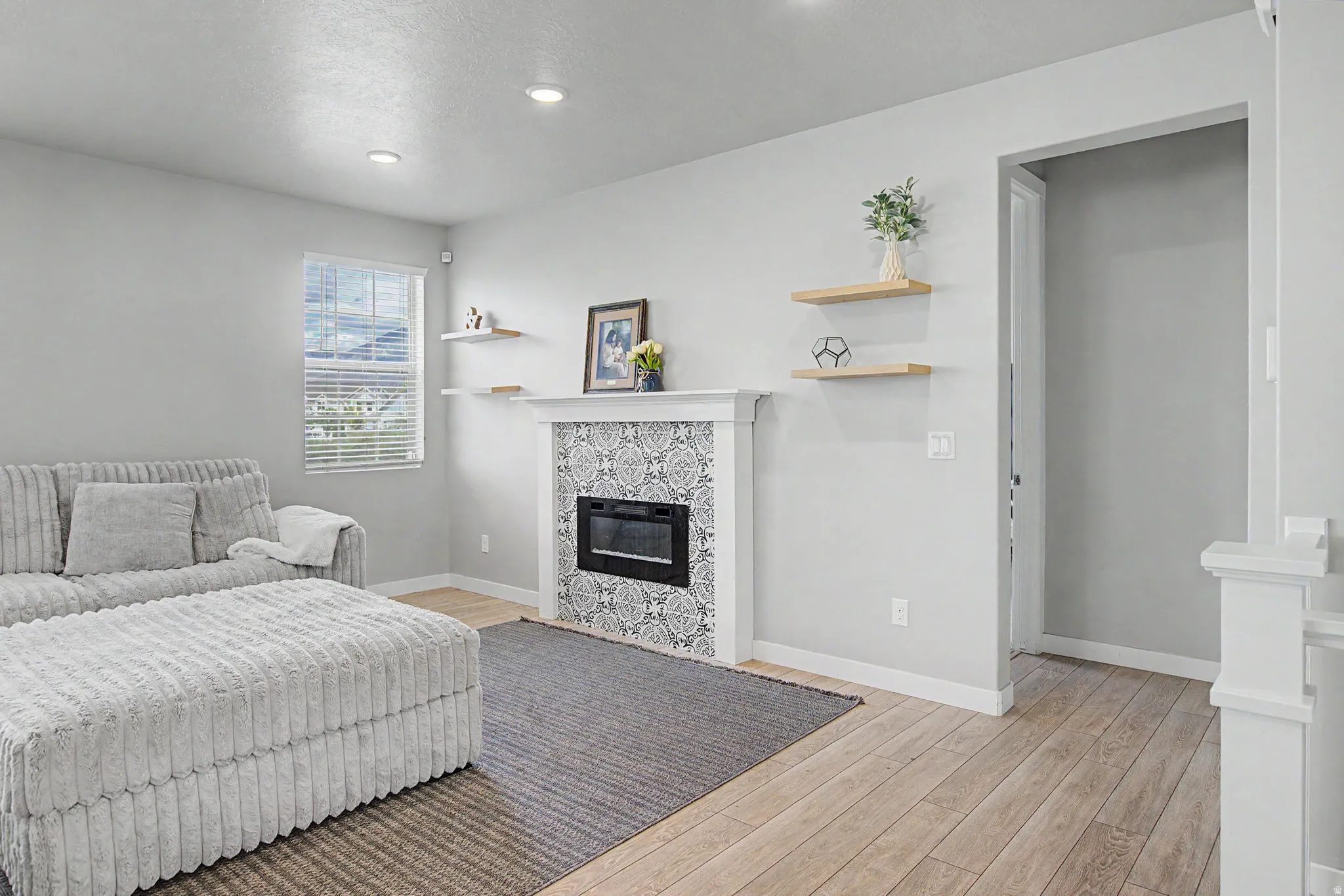 Fireplace featuring a decorative tile surround and white mantel
