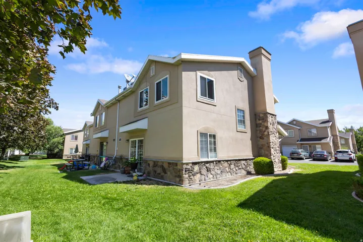 Stucco exterior with a stone veneer foundation and chimney
