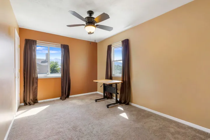 Light carpeting, dual windows, and ceiling fan