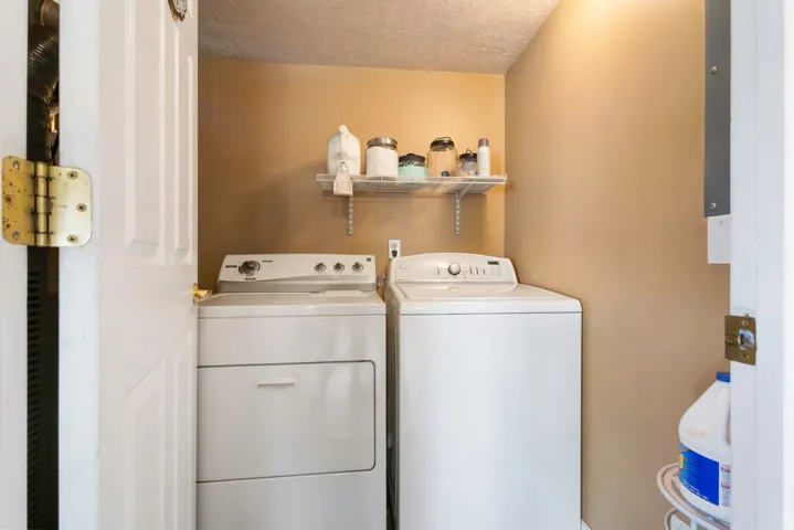 Dedicated laundry area featuring a shelf and painted walls
