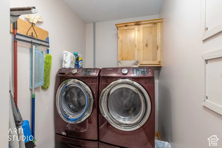 Laundry area with overhead wood cabinetry